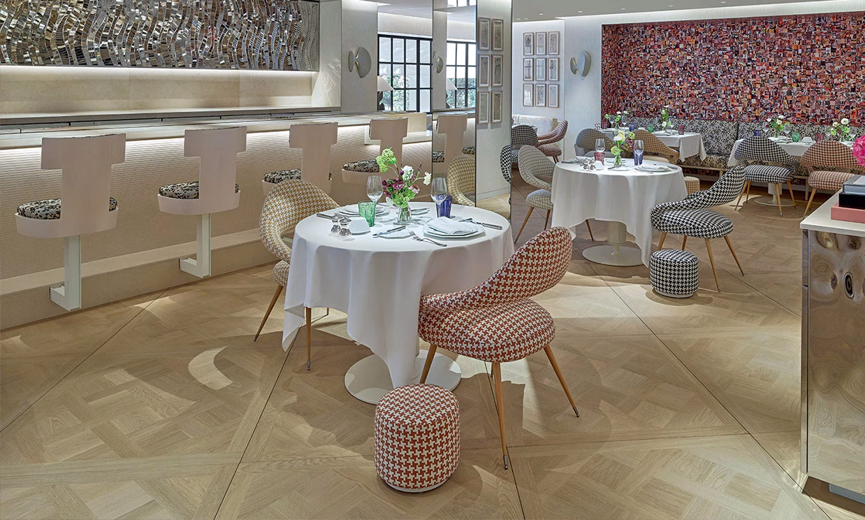 Interior dining area of Café Dior in Highland Park Village featuring elegant white and gray decor